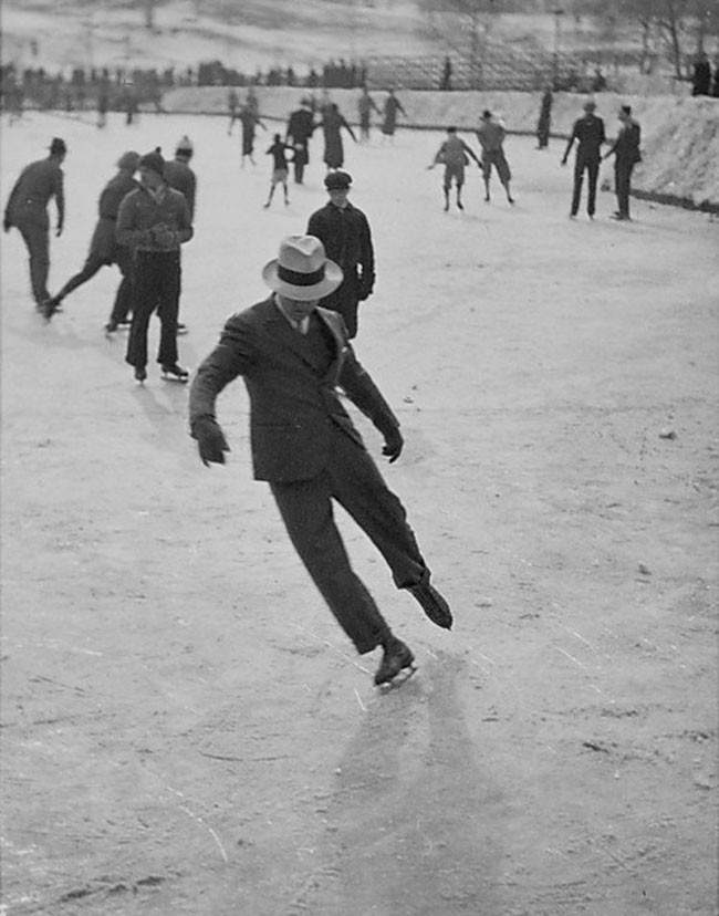 A man ice skating in a suit (1937).