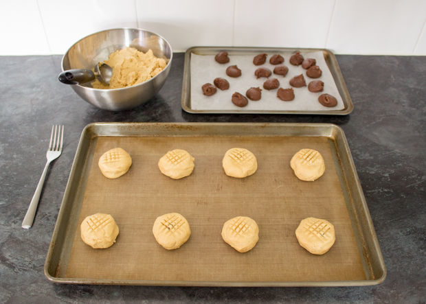 Take your frozen nutella and carefully wrap the peanut butter cookie dough around each dollop.