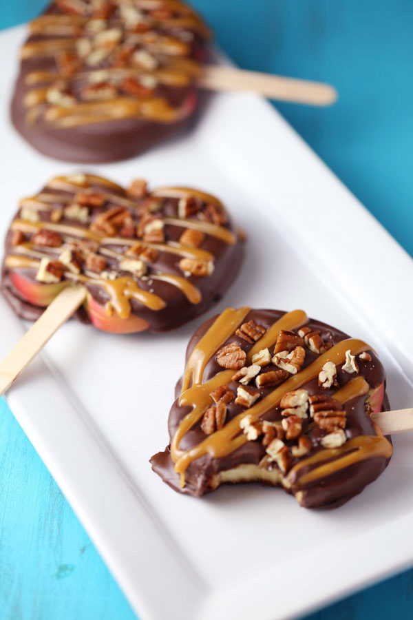 Trick your kids into eating apple slices by covering them in chocolate and putting them on a stick.