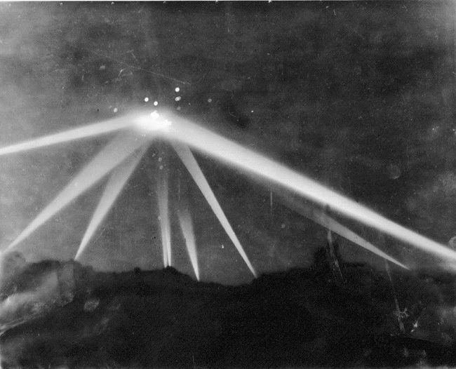 Battle of LA: A photo published in the Los Angeles Times on February 26, 1942 has been cited by modern day conspiracy theorists and UFOlogists as evidence of an extra-terrestrial visitation. They assert that the photo clearly shows searchlights focused on an alien spaceship; however, the photo was heavily modified by photo retouching prior to publication, a routine practice in graphic arts of the time intended to improve contrast in black and white photos. Los Angeles Times writer Larry Harnish noted that the retouched photo along with faked newspaper headlines were presented as true historical material in trailers for the film Battle: Los Angeles. Harnish commented, "if the publicity campaign wanted to establish UFO research as nothing but lies and fakery, it couldn't have done a better job."