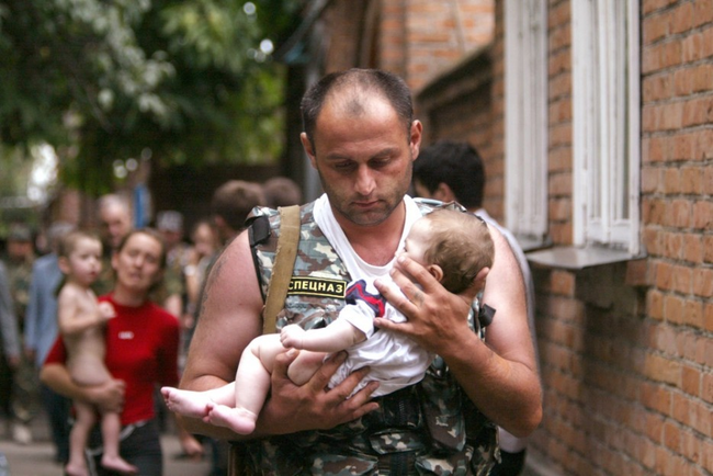 A Russian police office carries a baby that was rescued from a school occupied by militants in the town of Beslan in 2004.