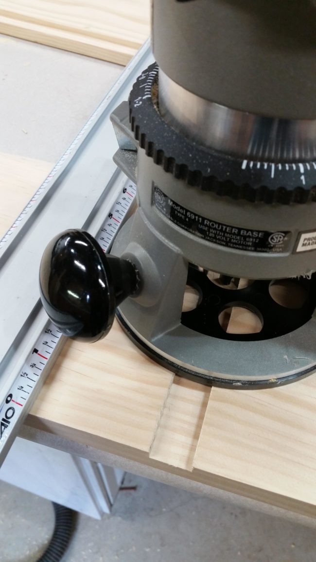 Using his router table, he cut a groove on the ends of the board and one in the middle of the piece he would use to divide the box into two sections.