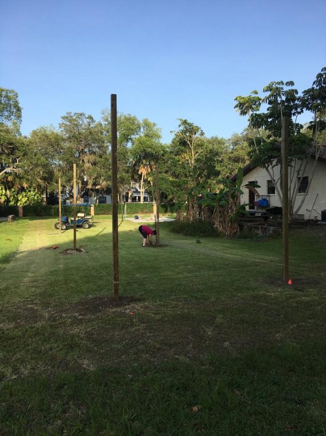 There needed to be six total posts, so after the first two were in the ground straight, he used string to help place the others.