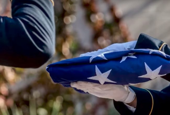 They honored him by draping a flag over his coffin while they carried it into the church for a moving service in his memory.