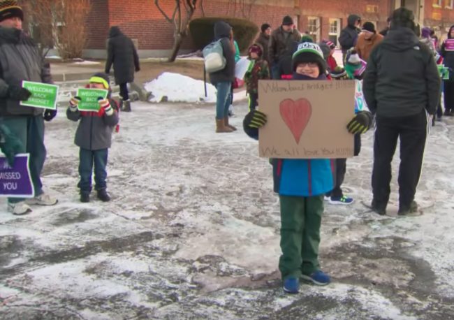 Adults and children alike showed up in temperatures that were well below freezing, holding up signs and cheering for her as she entered Merrymount Elementary School in Massachusetts.