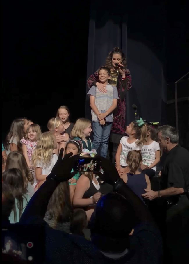 Before singing “Let It Go,” Menzel admitted that whenever she calls a boy on stage, they say they don't like "Frozen." But this guy isn't most boys.